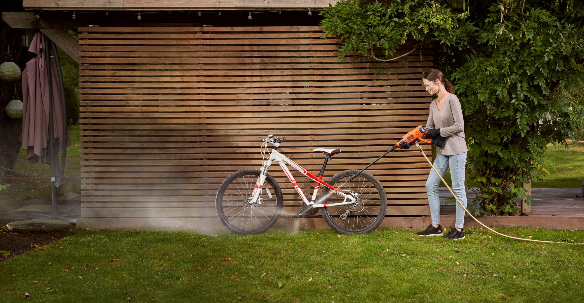 Cordless Power Cleaner Kit being used by person to clean bicycle.